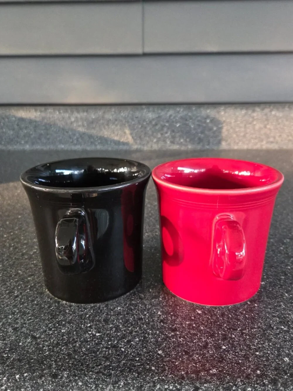 Fiestaware ceramic mugs in black and red with a ring handle, 10.25 oz capacity.